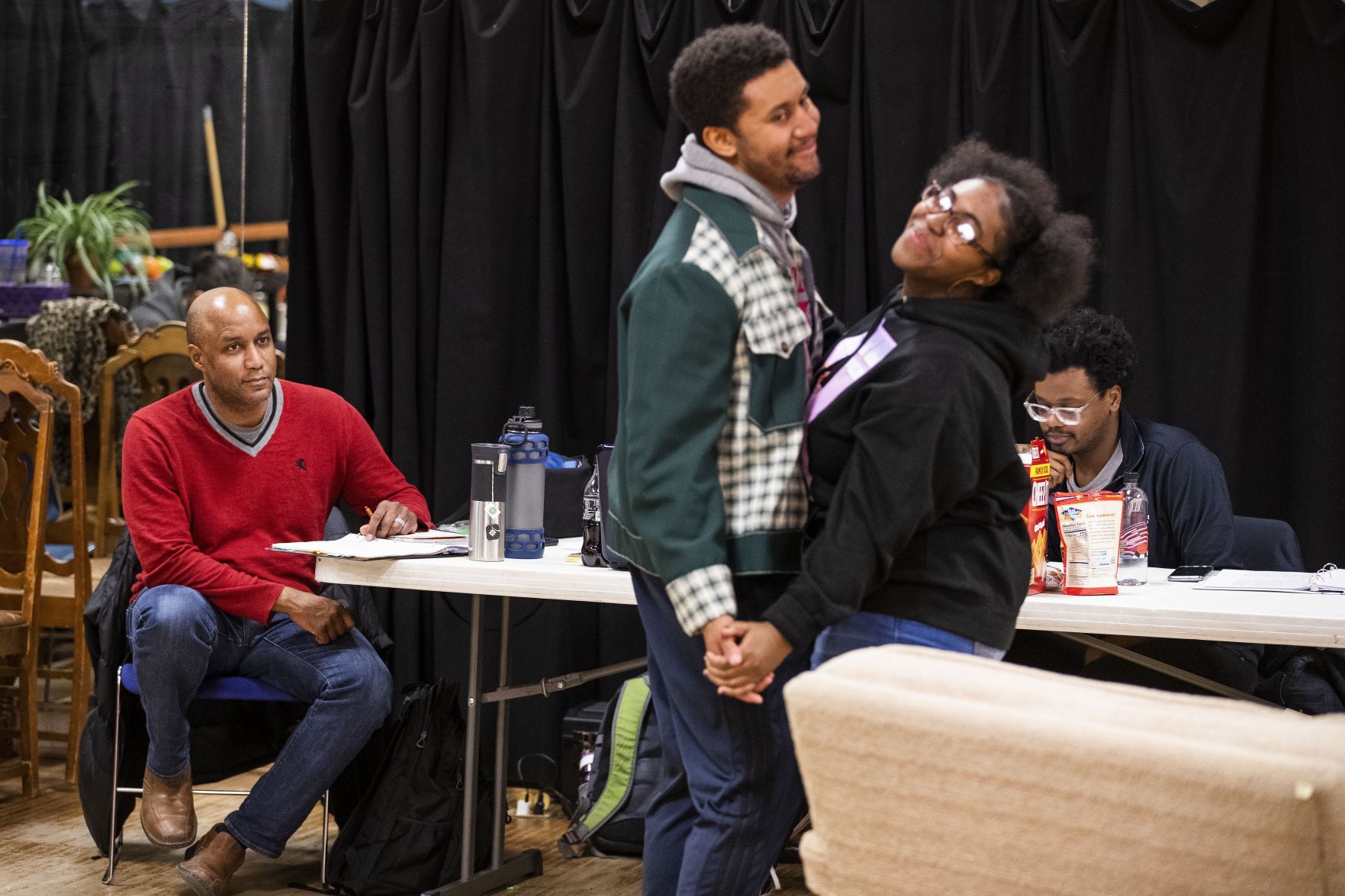 Tyrone Beasley looks on at David Terrell Green performing as Walter Younger and Faushia Weeden performing Ruth Younger during a rehearsal.